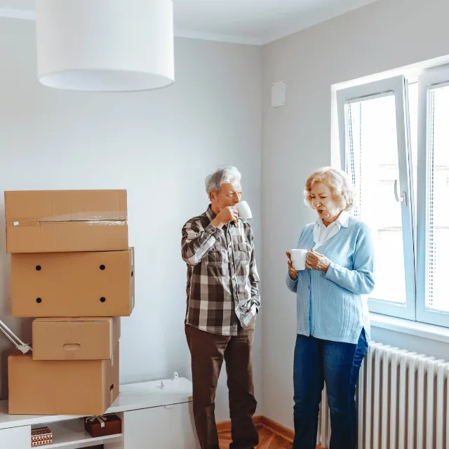 old couple getting ready to move drink coffee 